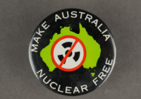 A black badge with a shape of Australia in green and the words make Australia nuclear free in white.