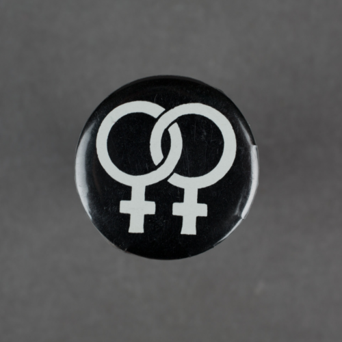 A black badge with two interlinked womans symbols in white.
