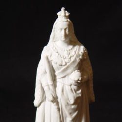 A small statue of queen Victoria in white ceramic.