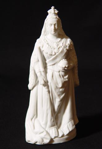 A small statue of queen Victoria in white ceramic.